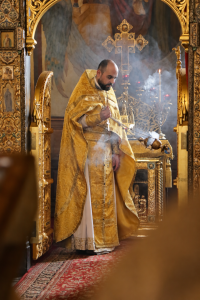 Orthodox Priest in Incense-Filled Sanctuary